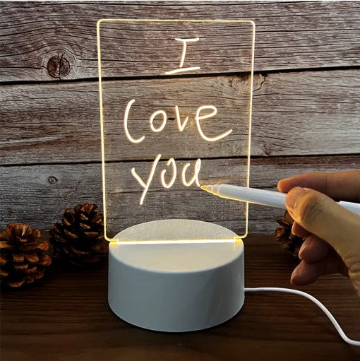 Lámpara Glowsy con el mensaje «I love you» escrito a mano en el tablero de acrílico
